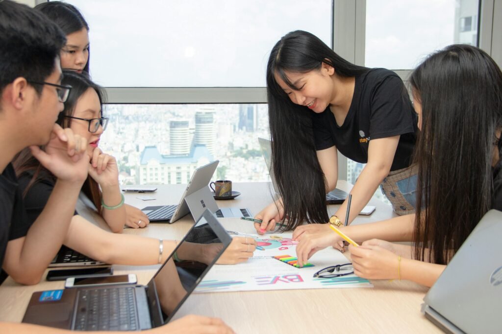 Group of colleagues engaged in a creative brainstorming session at an urban office space.