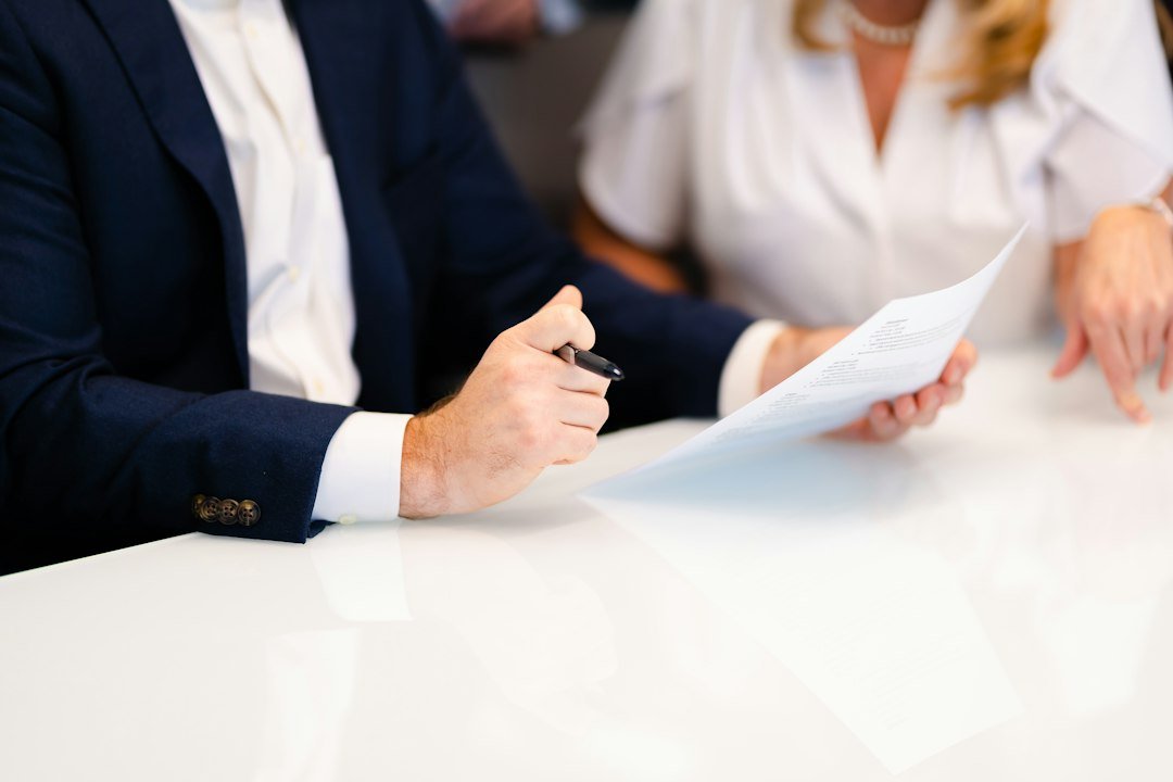 Two colleagues sitting at a white table during a working meeting