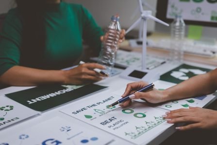 Environmentalists analyzing data about plastic pollution and renewable energies, developing strategies for a sustainable future